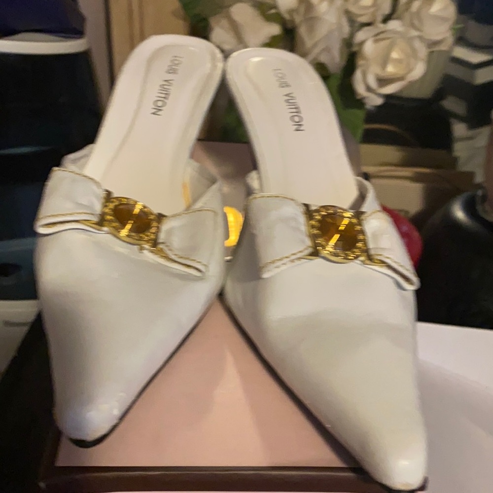 Luis Vuitton white loafers with gold accessories